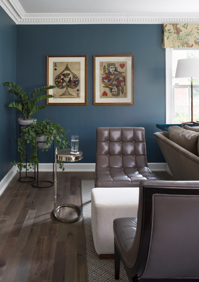 This is an example of a large transitional enclosed family room in Chicago with blue walls, medium hardwood floors and brown floor.