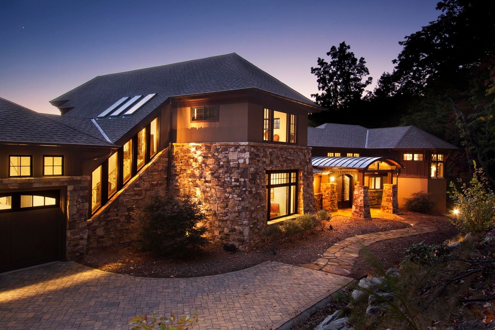 Example of a huge transitional brown two-story stone exterior home design