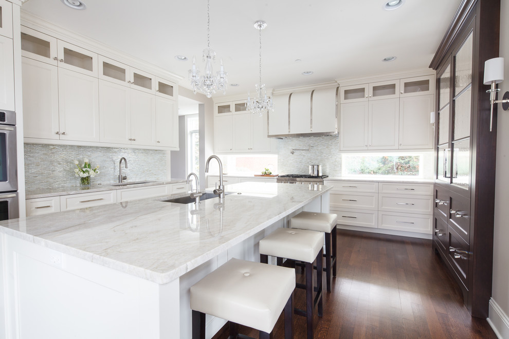 Inspiration for a traditional u-shaped kitchen in Chicago with an undermount sink, recessed-panel cabinets, white cabinets and beige splashback.