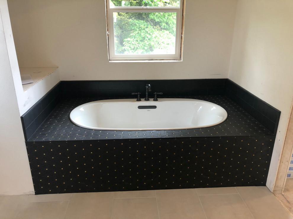 This is an example of a mid-sized contemporary bathroom in Portland with a drop-in tub, beige walls, ceramic floors and beige floor.