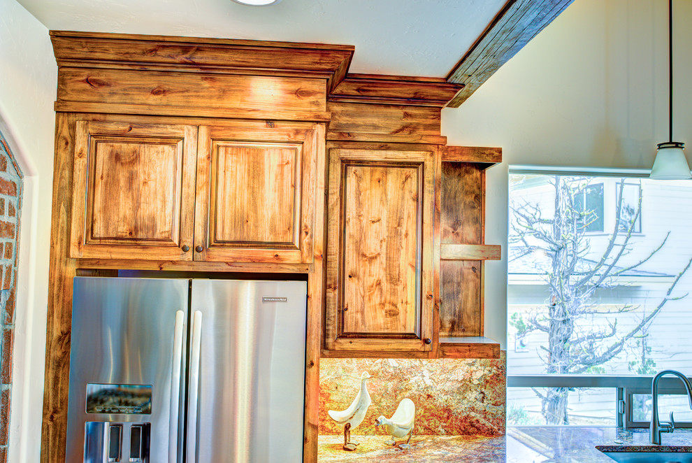 Inspiration for a large rustic u-shaped medium tone wood floor kitchen pantry remodel with a drop-in sink, glass-front cabinets, medium tone wood cabinets, beige backsplash, stainless steel appliances and an island