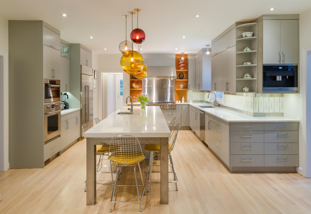 Large contemporary u-shaped kitchen/diner in Richmond with a submerged sink, flat-panel cabinets, grey cabinets, engineered stone countertops, beige splashback, ceramic splashback, stainless steel appliances, light hardwood flooring, an island, beige floors and grey worktops.