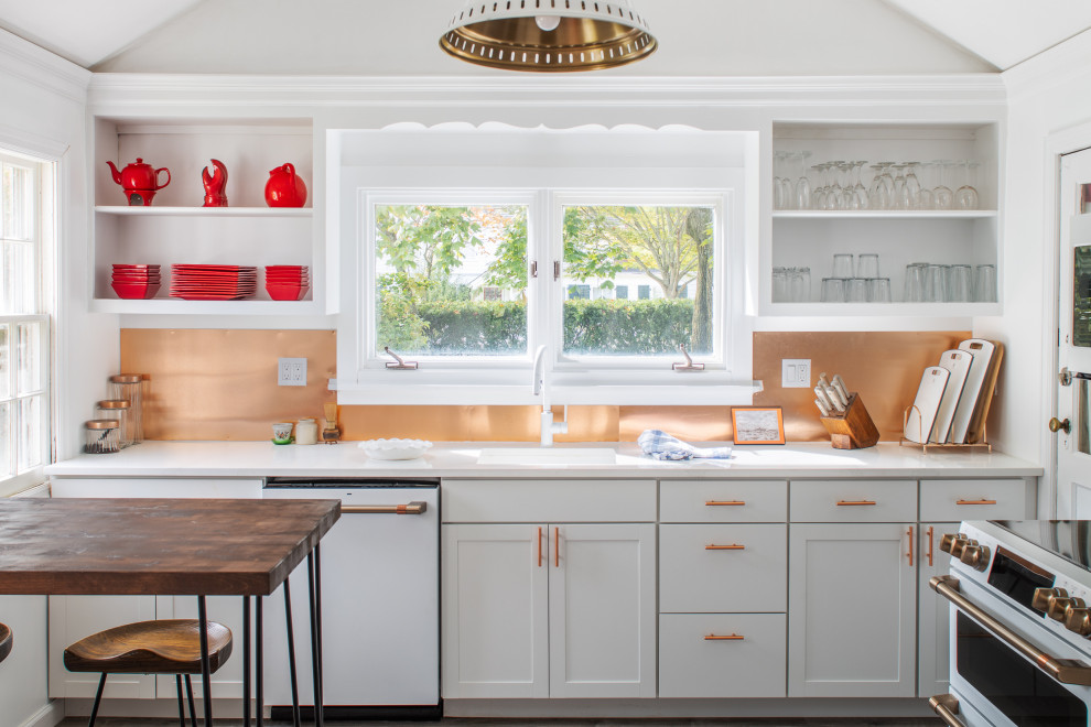 Design ideas for a mid-sized traditional single-wall separate kitchen in New York with shaker cabinets, white cabinets, no island, an undermount sink, marble benchtops, metallic splashback, white appliances, dark hardwood floors, brown floor, white benchtop and vaulted.