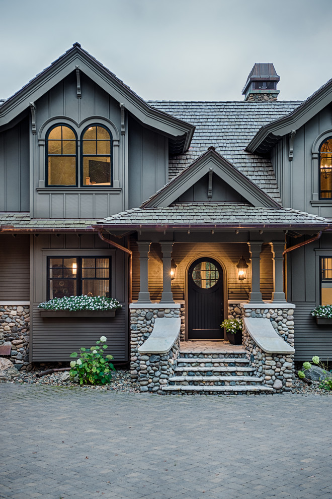 Photo of a traditional two-storey grey exterior in Minneapolis with wood siding and a gable roof.