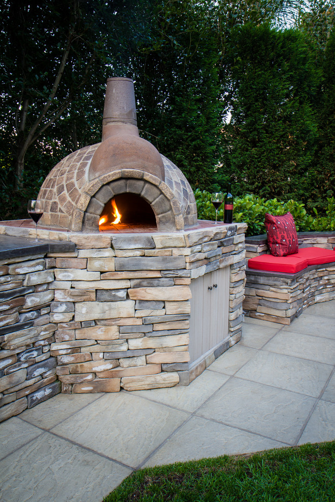 Mountain style backyard concrete paver full sun patio photo