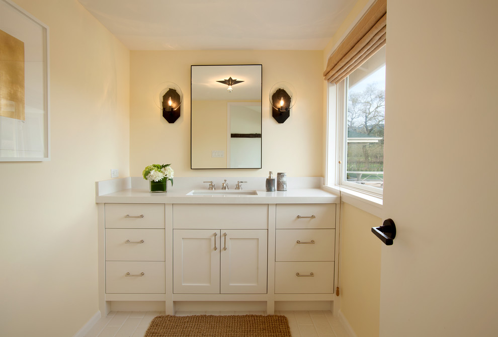 This is an example of a mid-sized transitional 3/4 bathroom in San Francisco with shaker cabinets, white cabinets, white walls, an undermount sink and engineered quartz benchtops.