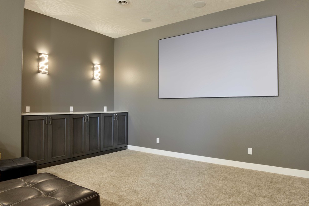 This is an example of a large modern home theatre in Other with grey walls and carpet.