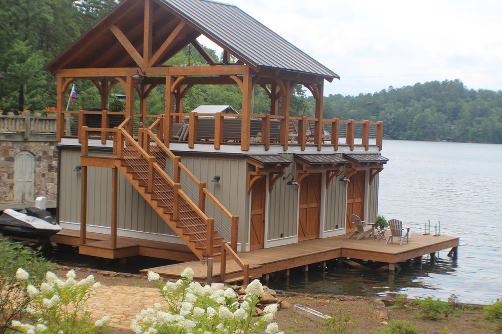 Large arts and crafts backyard deck in Atlanta with with dock and an awning.