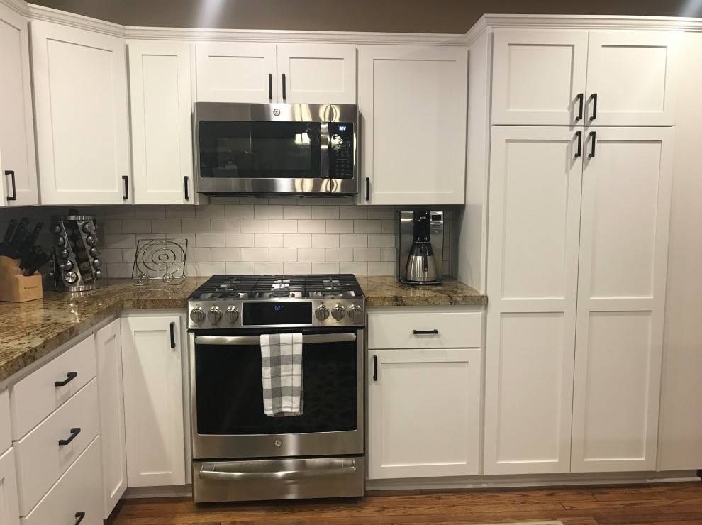 Kitchen photo in Phoenix with shaker cabinets, white cabinets, white backsplash and ceramic backsplash
