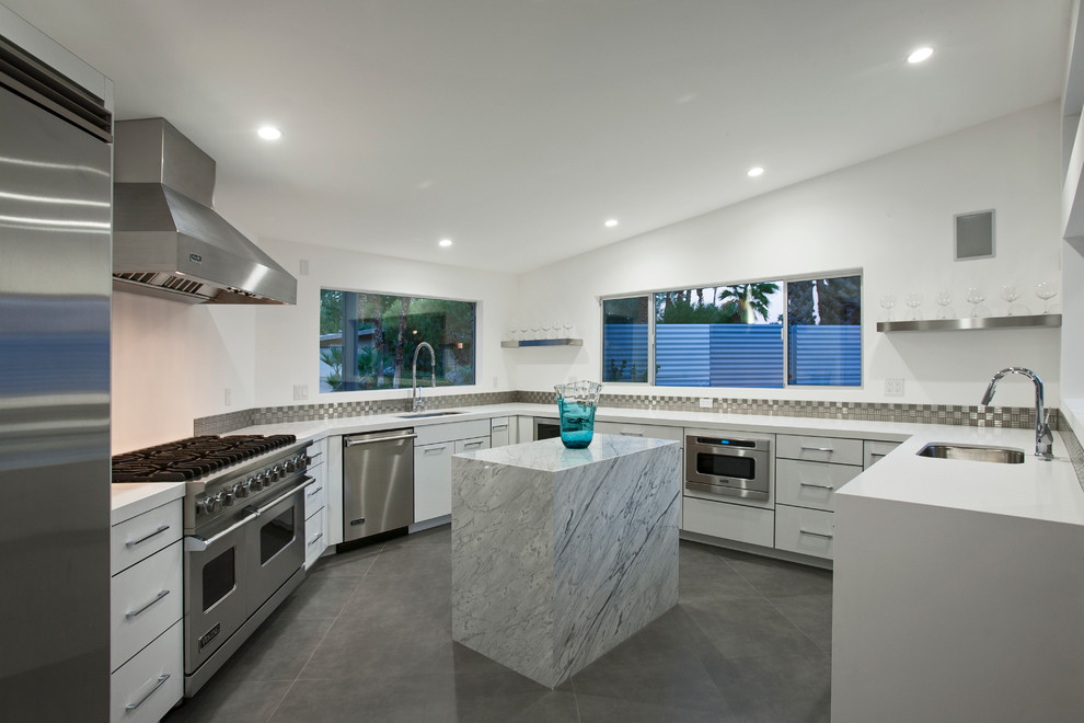This is an example of a large contemporary u-shaped kitchen in Other with an undermount sink, flat-panel cabinets, white cabinets, quartz benchtops, metallic splashback, metal splashback, stainless steel appliances, porcelain floors and with island.