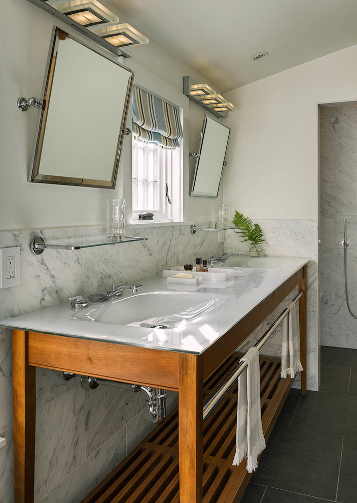 Photo of a mid-sized traditional master bathroom in Bridgeport with shaker cabinets, medium wood cabinets, a freestanding tub, an alcove shower, marble, white walls, ceramic floors, an undermount sink, marble benchtops, grey floor and an open shower.