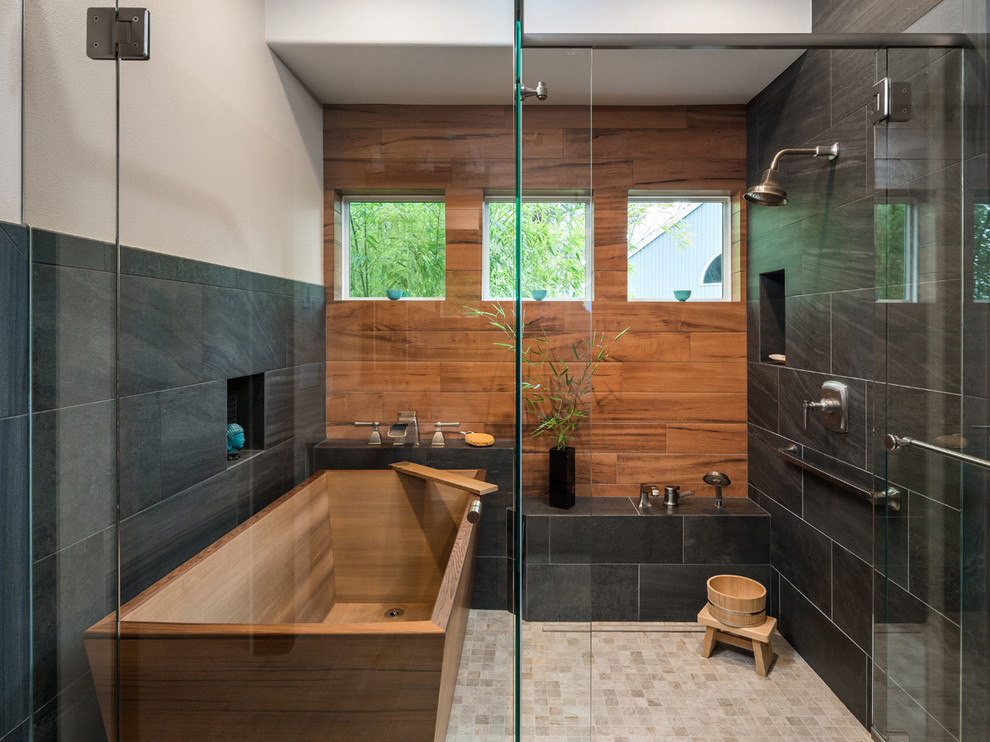This is an example of a transitional bathroom in Portland with a freestanding tub, an alcove shower, black tile, brown tile, porcelain tile, beige walls, porcelain floors, beige floor and a hinged shower door.