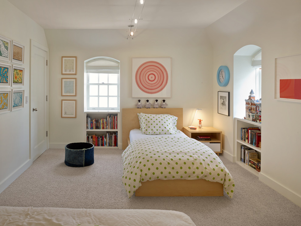 This is an example of a contemporary kids' bedroom for kids 4-10 years old and boys in San Francisco with white walls, carpet and beige floor.