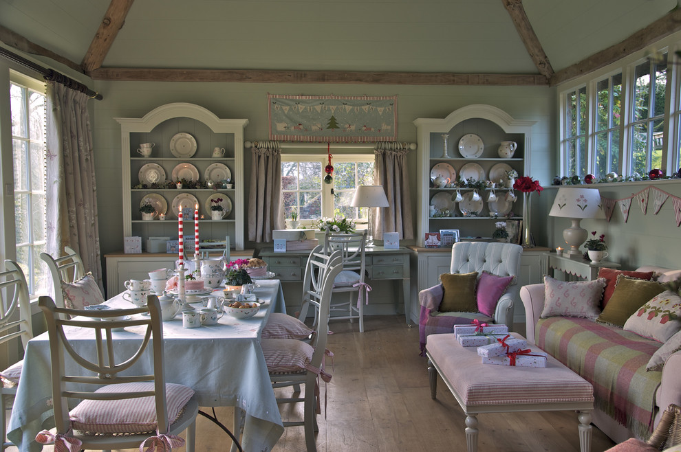 Design ideas for an expansive country dining room in Wiltshire with green walls and medium hardwood floors.