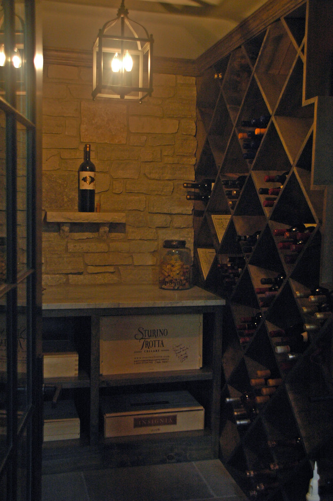 Inspiration for a mid-sized country wine cellar in Chicago with slate floors and diamond bins.
