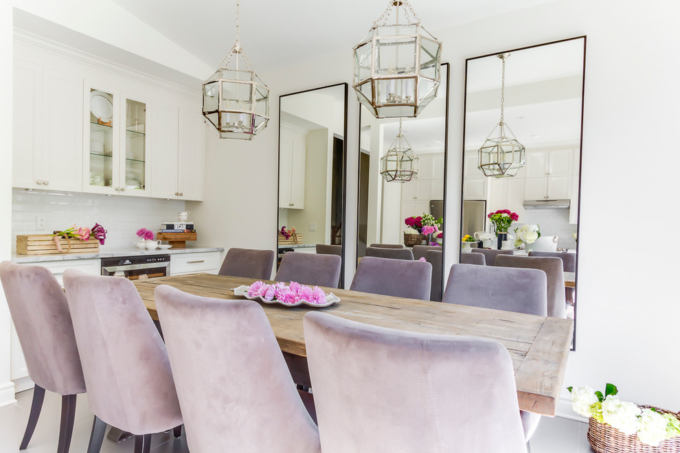 This is an example of a country dining room in Montreal with white walls.