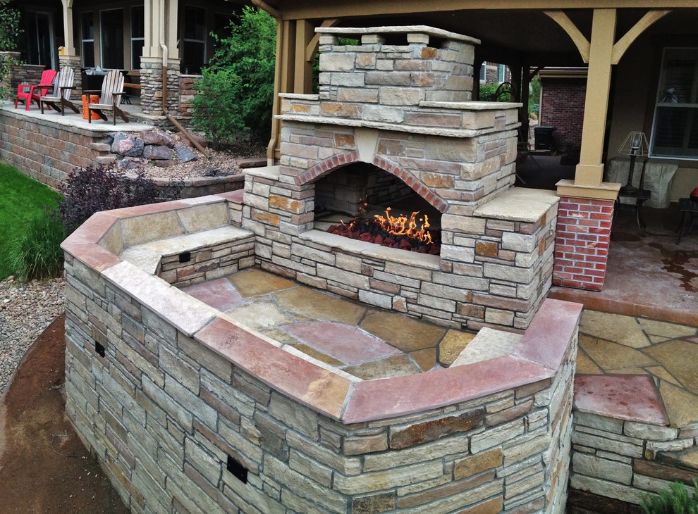 Design ideas for a small country backyard patio in Denver with a fire feature, natural stone pavers and no cover.