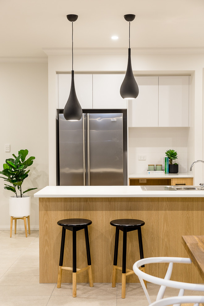 Inspiration for a small contemporary open plan kitchen in Adelaide with a double-bowl sink, stainless steel appliances, ceramic floors and with island.