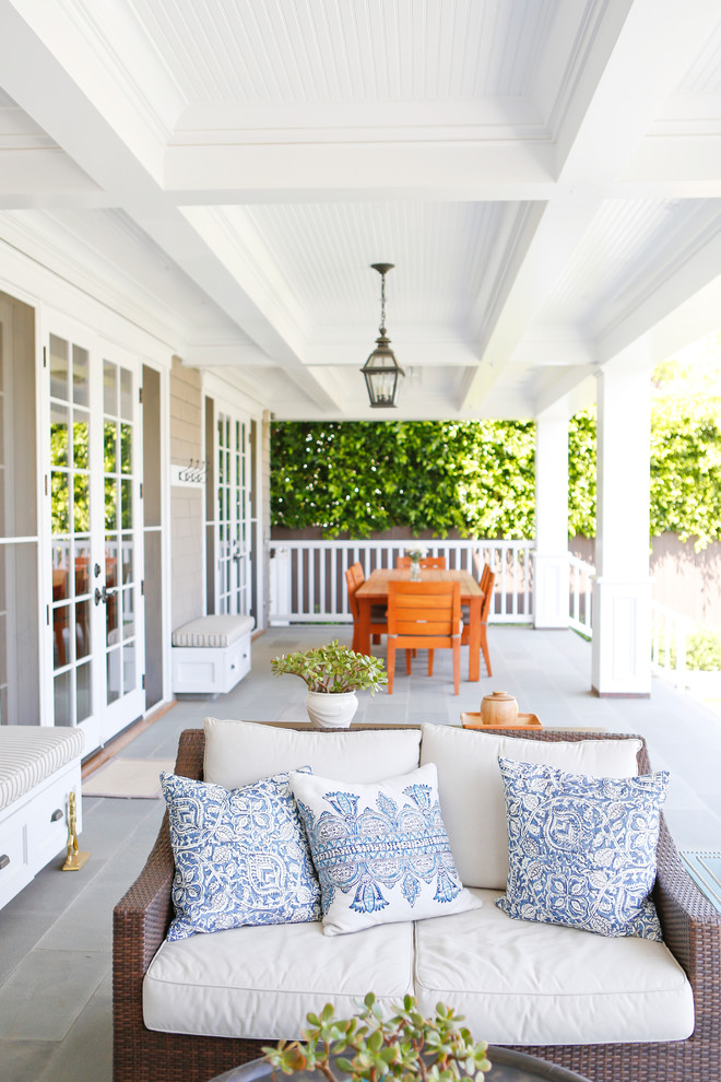 Design ideas for a mid-sized transitional backyard verandah in Los Angeles with concrete pavers and a roof extension.