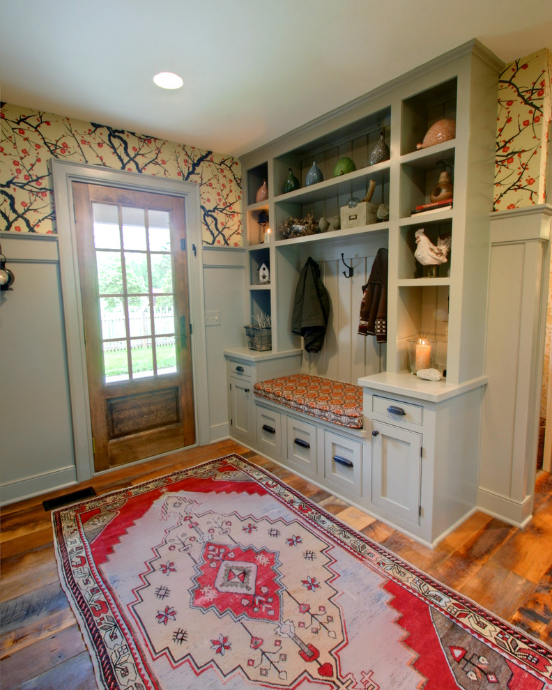 Traditional entryway in Columbus with multi-coloured walls and dark hardwood floors.