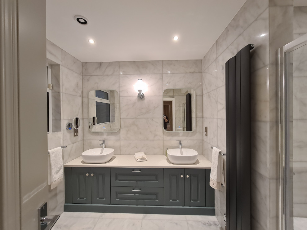 Bathroom - mid-sized contemporary 3/4 white tile and marble tile marble floor, white floor and double-sink bathroom idea in Dublin with flat-panel cabinets, blue cabinets, a one-piece toilet, white walls, a drop-in sink, marble countertops, white countertops and a built-in vanity