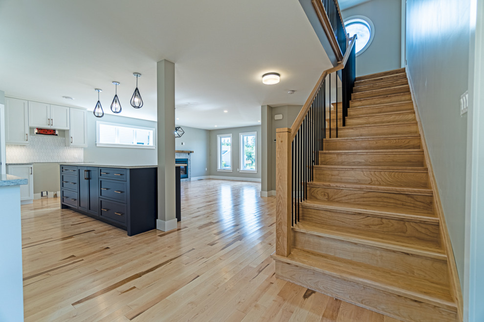 Eat-in kitchen - mid-sized transitional light wood floor and beige floor eat-in kitchen idea with shaker cabinets, white cabinets, granite countertops, an island and gray countertops
