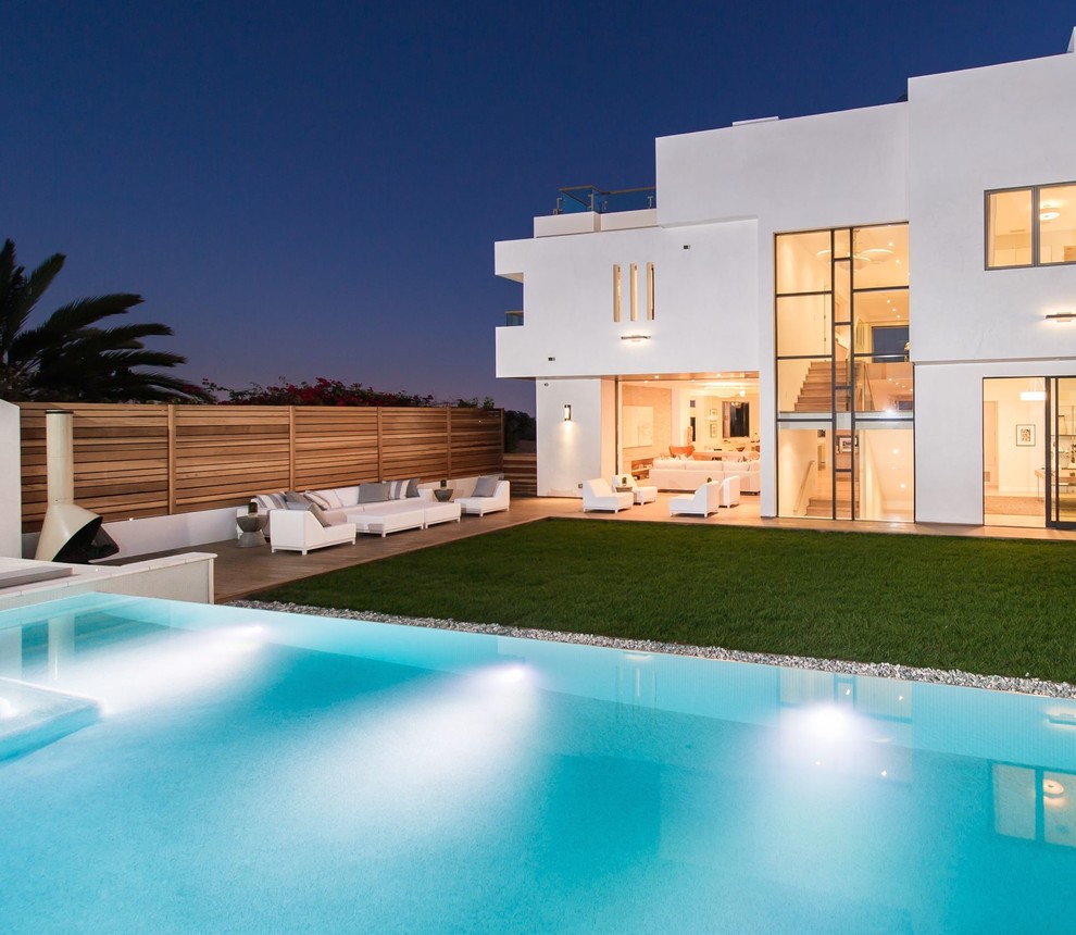Large modern three-storey stucco white exterior in Los Angeles with a flat roof.