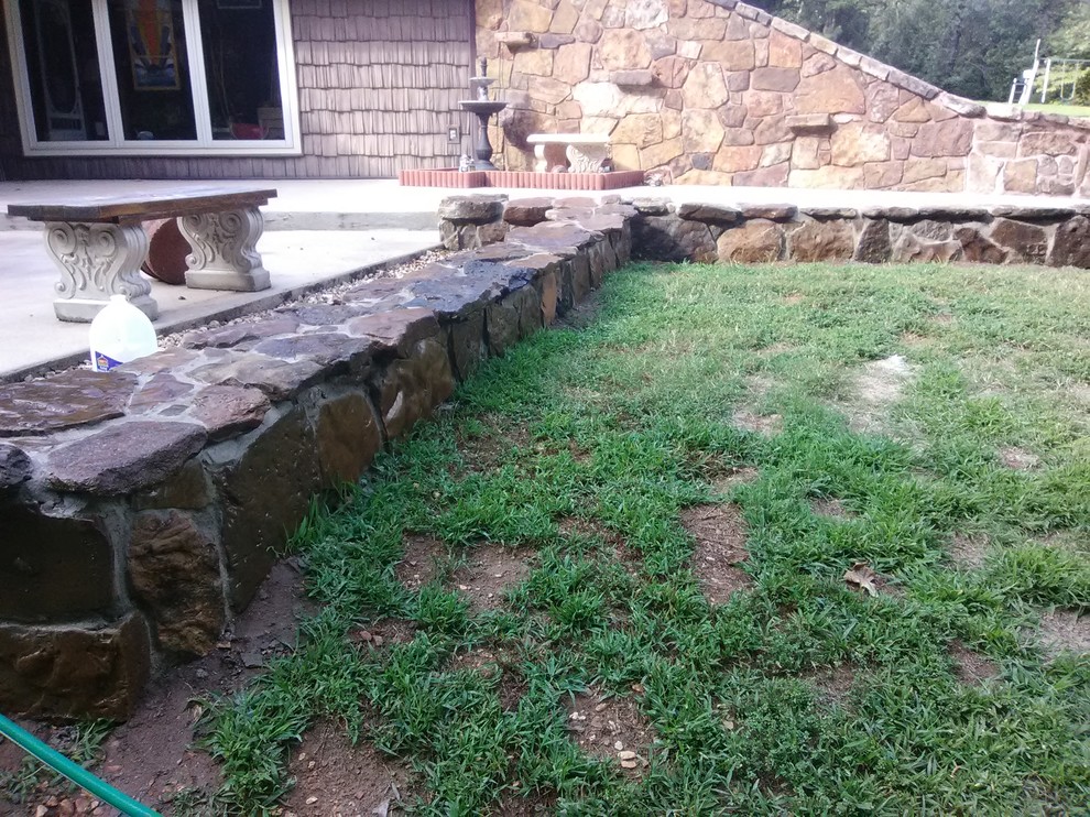 This is an example of a mid-sized contemporary full sun garden in Other with a retaining wall.