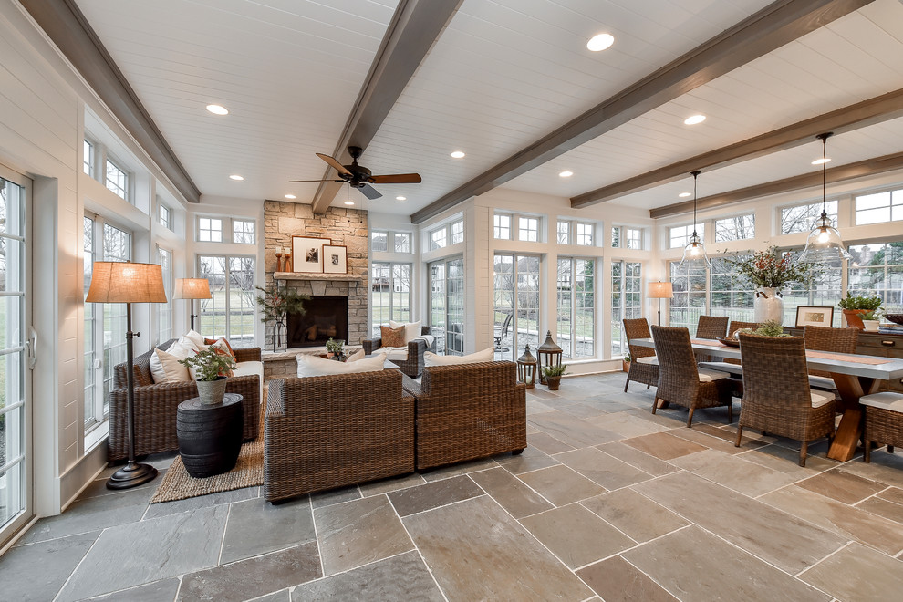 Inspiration for a country sunroom in Chicago with slate floors, a standard fireplace, a stone fireplace surround and a standard ceiling.