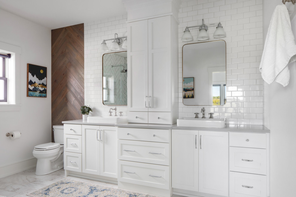Photo of a mid-sized country bathroom in Milwaukee with shaker cabinets, white cabinets, white tile, subway tile, white walls, a drop-in sink, white floor, grey benchtops, a double vanity and a built-in vanity.