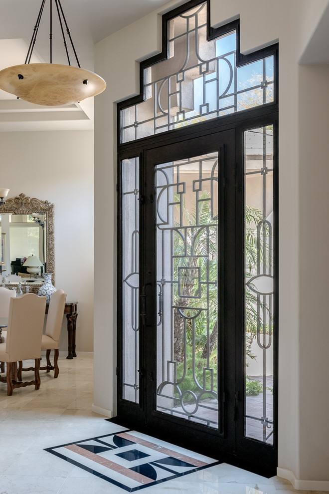 This is an example of a large traditional foyer in Phoenix with beige walls, marble floors, a single front door, a metal front door and beige floor.