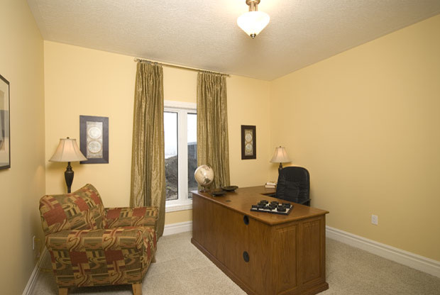 Study room - large traditional freestanding desk carpeted study room idea in Toronto with yellow walls and no fireplace