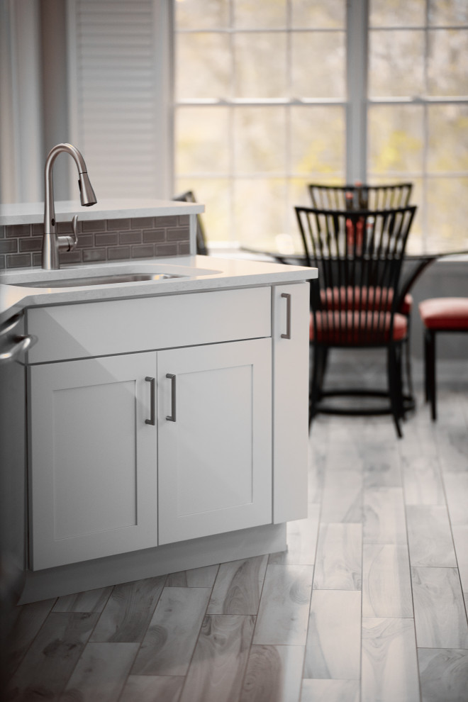 Example of a mid-sized transitional galley porcelain tile and multicolored floor eat-in kitchen design with an undermount sink, recessed-panel cabinets, white cabinets, quartz countertops, gray backsplash, ceramic backsplash, stainless steel appliances, a peninsula and white countertops