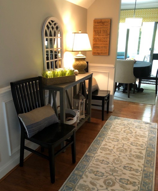 This is an example of a mid-sized transitional foyer in Philadelphia with beige walls, medium hardwood floors, a single front door, a dark wood front door and brown floor.
