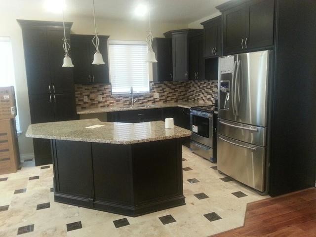 Inspiration for a large galley light wood floor enclosed kitchen remodel in Cedar Rapids with a drop-in sink, flat-panel cabinets, black cabinets, metallic backsplash and an island