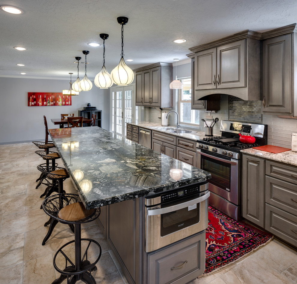 Photo of a mid-sized modern single-wall eat-in kitchen in Houston with an undermount sink, raised-panel cabinets, grey cabinets, marble benchtops, white splashback, ceramic floors, with island and beige floor.