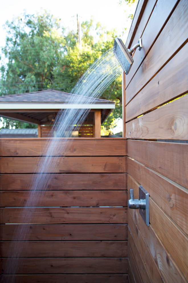 Large minimalist backyard concrete outdoor patio shower photo in San Luis Obispo with a gazebo