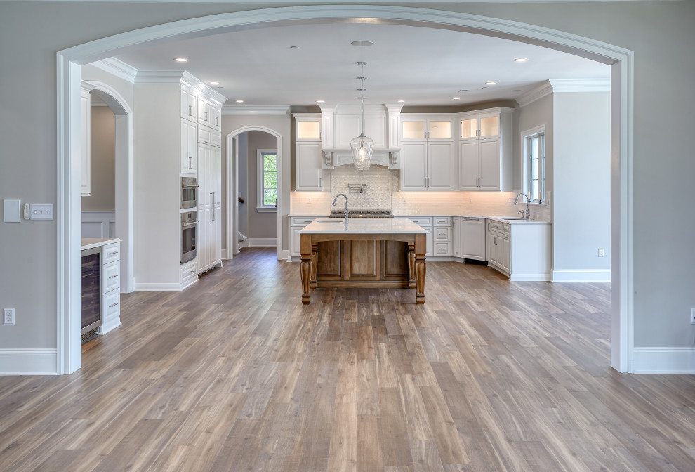 Transitional Kitchen with Two Toned Gathering Island & Archways