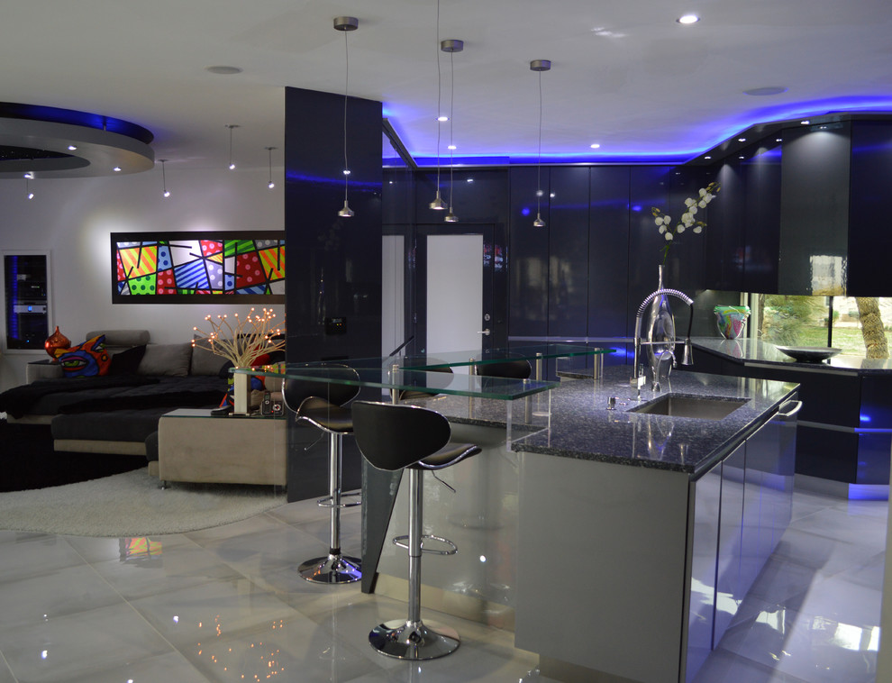 Example of a large minimalist u-shaped porcelain tile eat-in kitchen design with an undermount sink, flat-panel cabinets, gray cabinets, quartz countertops, metallic backsplash, glass sheet backsplash, stainless steel appliances and an island
