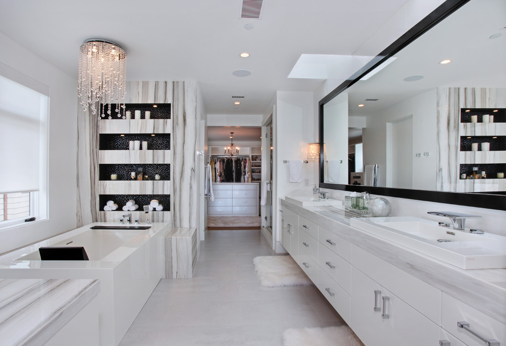 Inspiration for a contemporary bathroom remodel in Orange County with flat-panel cabinets, white cabinets, white walls and a drop-in sink