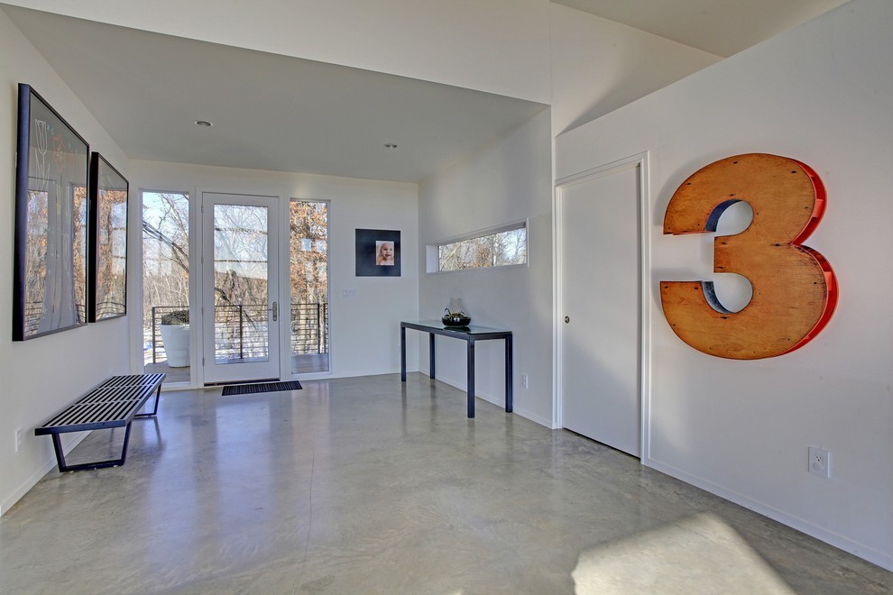 Design ideas for a modern entryway in Minneapolis with concrete floors and white walls.