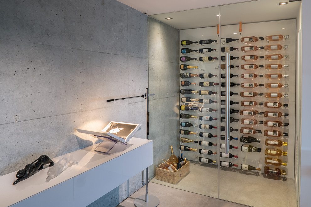 Design ideas for a contemporary wine cellar in Miami with concrete floors, display racks and grey floor.