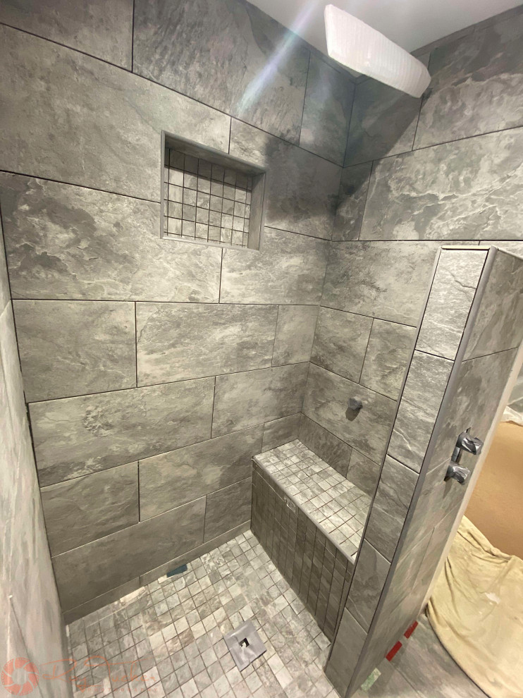Photo of a small contemporary master bathroom in Other with a curbless shower, a two-piece toilet, gray tile, porcelain tile, grey walls, porcelain floors, a pedestal sink, grey floor, an open shower, a shower seat and a single vanity.