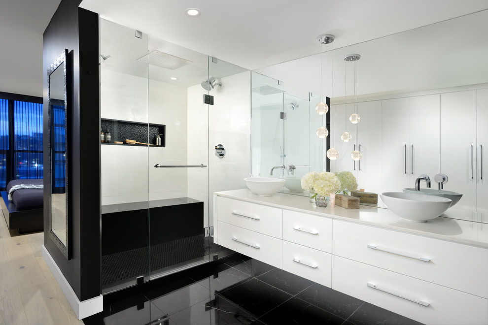 Inspiration for a contemporary master bathroom in Toronto with flat-panel cabinets, white cabinets, a double shower, white tile, white walls, a vessel sink, black floor, a hinged shower door and white benchtops.