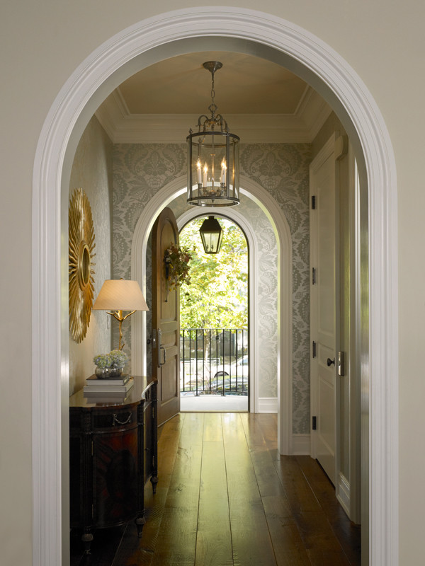 This is an example of a mid-sized traditional foyer in Chicago with dark hardwood floors, metallic walls, a single front door and a dark wood front door.