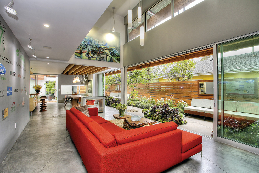 Inspiration for a large modern open concept concrete floor living room remodel in Los Angeles with gray walls and no fireplace