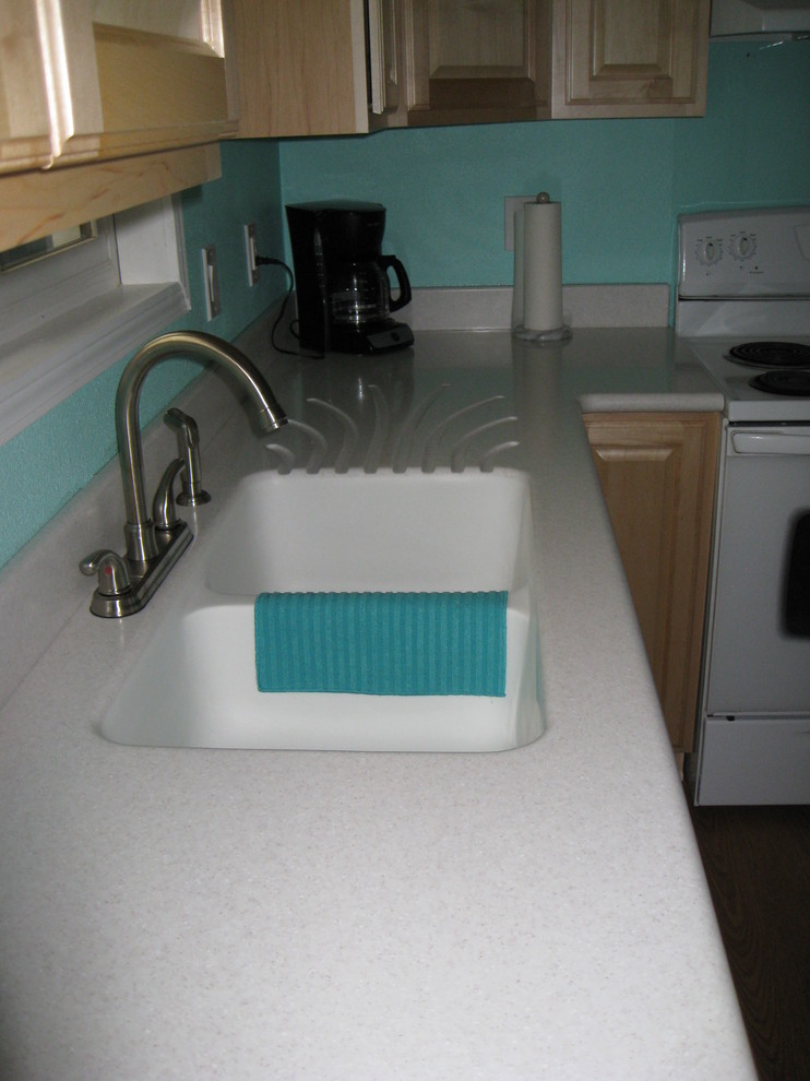 Inspiration for a timeless kitchen remodel with an integrated sink and solid surface countertops