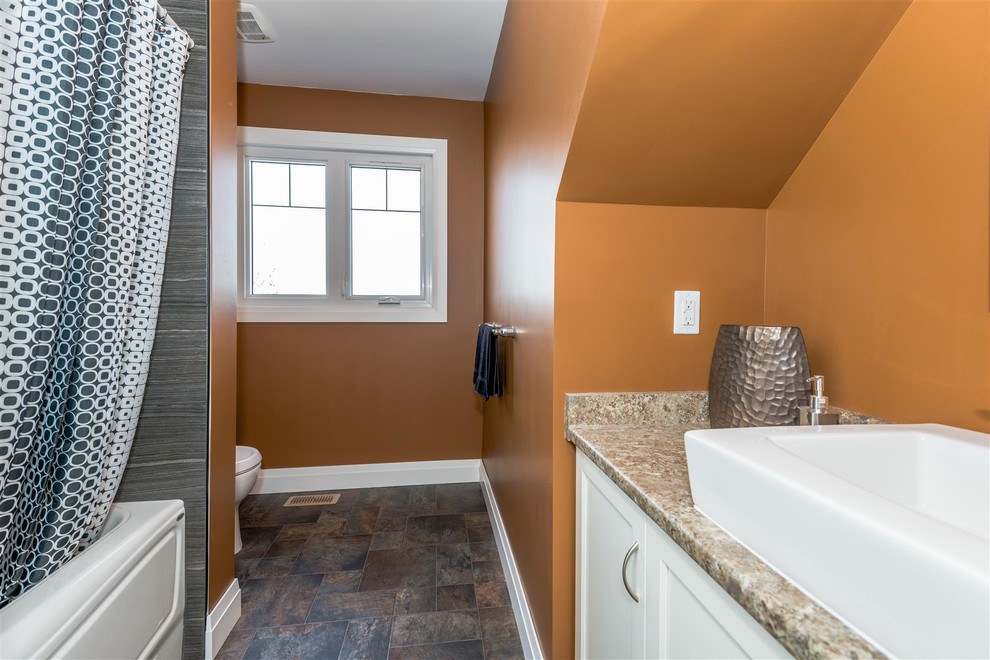 Mid-sized contemporary 3/4 bathroom in Other with shaker cabinets, white cabinets, an alcove tub, a shower/bathtub combo, orange walls, porcelain floors, a vessel sink, granite benchtops, multi-coloured floor, a shower curtain and multi-coloured benchtops.