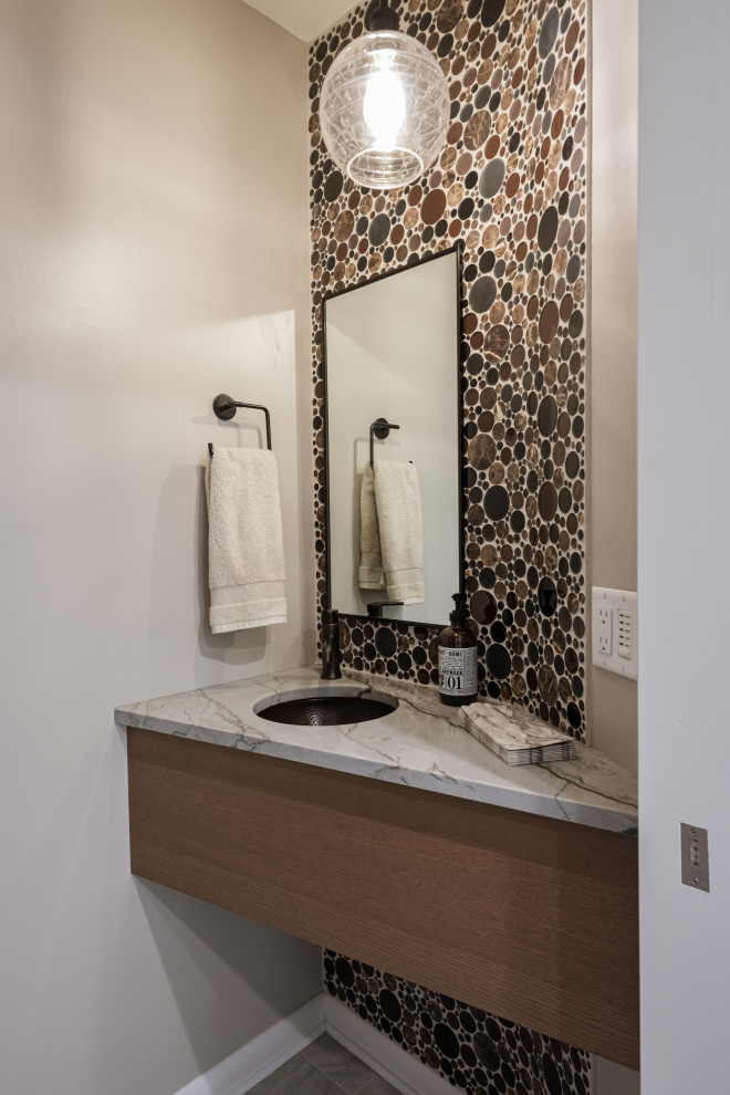 Photo of a small midcentury cloakroom in Milwaukee with flat-panel cabinets, brown cabinets, multi-coloured tiles, mosaic tiles, grey walls, porcelain flooring, a submerged sink, quartz worktops, grey floors, multi-coloured worktops and a floating vanity unit.