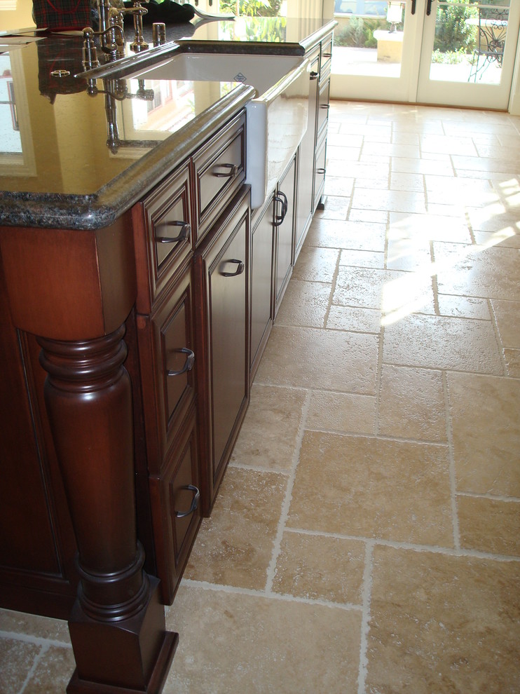 Example of a large mountain style galley open concept kitchen design with beaded inset cabinets, medium tone wood cabinets, granite countertops, beige backsplash, an island and brown countertops